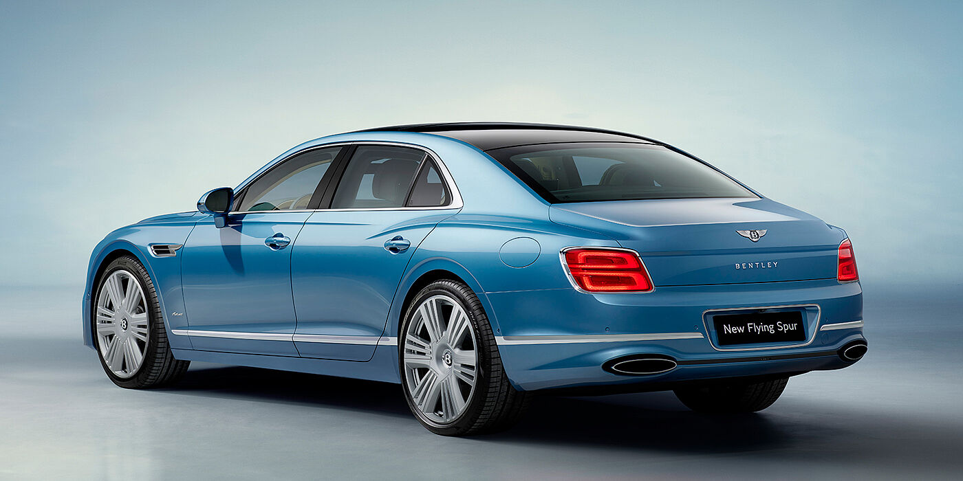 Bentley Dubai New Bentley Flying Spur Azure sedan rear view in Light windsor blue by Mulliner paint with 22 inch Azure wheels and chrome exterior details