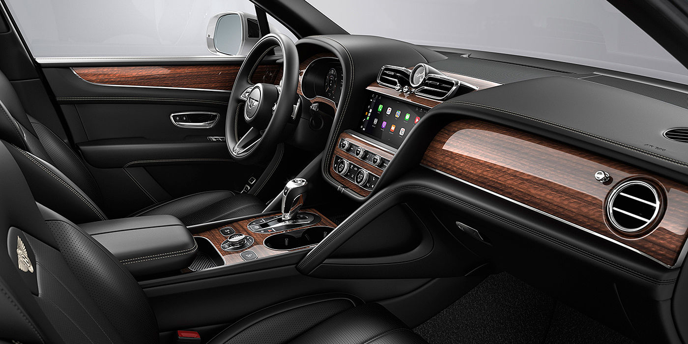 Bentley Emirates -  Dubai Bentley Bentayga interior with a Crown Cut Walnut veneer, view from the passenger seat over looking the driver's seat.
