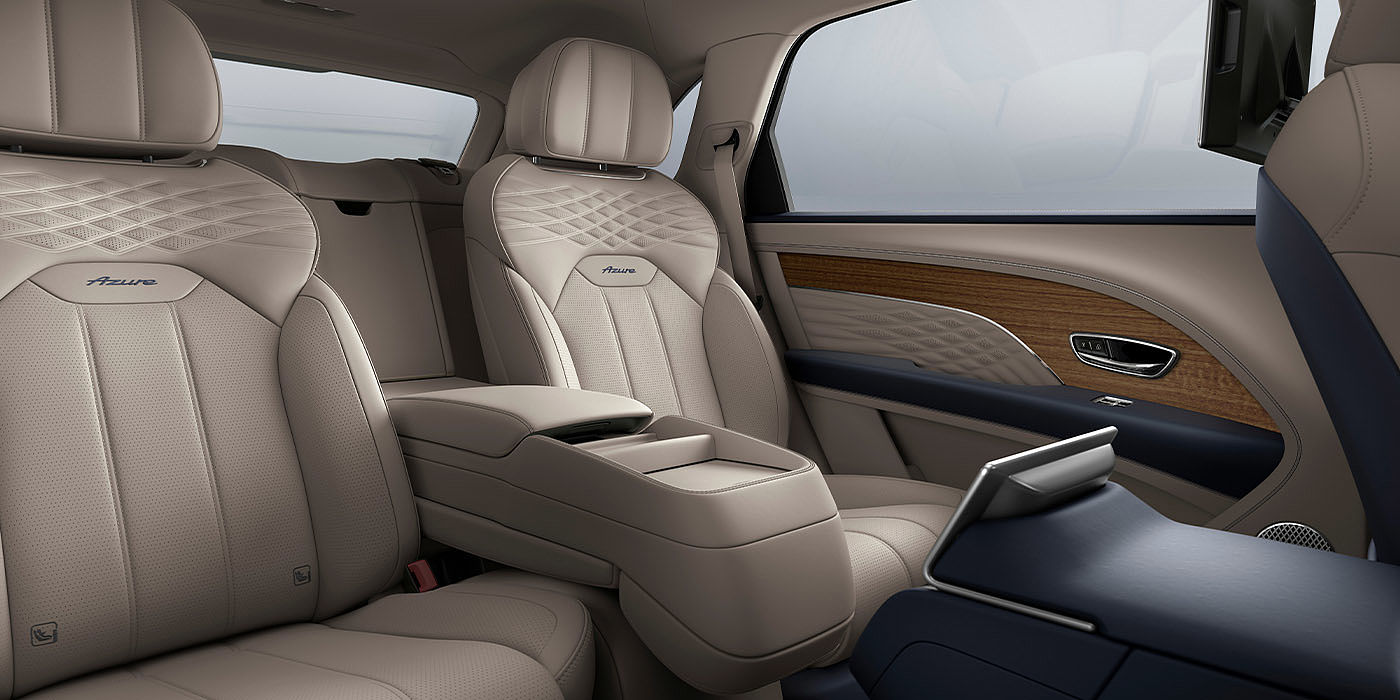 Bentley Emirates -  Dubai Bentley Bentayga EWB Azure interior view for rear passengers with Portland hide featuring Azure Emblem in Imperial Blue contrast stitch.