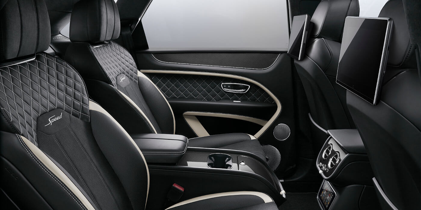 Bentley Emirates -  Dubai Bentley Bentayga Speed SUV rear interior in Beluga black and Linen hide with carbon fibre veneer