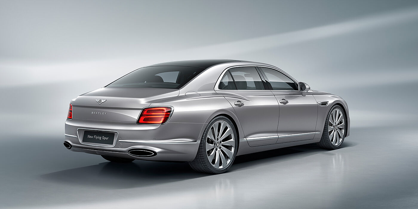 Bentley Dubai New Bentley Flying Spur sedan rear view in Silverlake paint with ten spoke wheels and chrome matrix grille