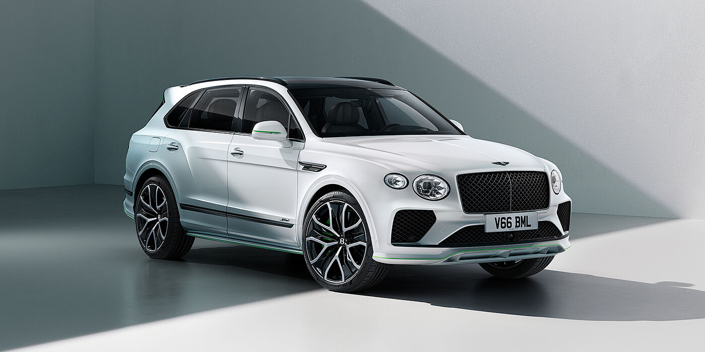 Bentley Dubai Bentley Bentayga Speed SUV front three quarter in Snow Quartz Pearlescent by Mulliner white paint against a grey wall