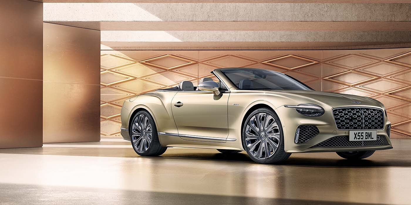 Bentley Dubai Bentley New Continental GTC Mulliner V8 hybrid front three quarters in Patina paint