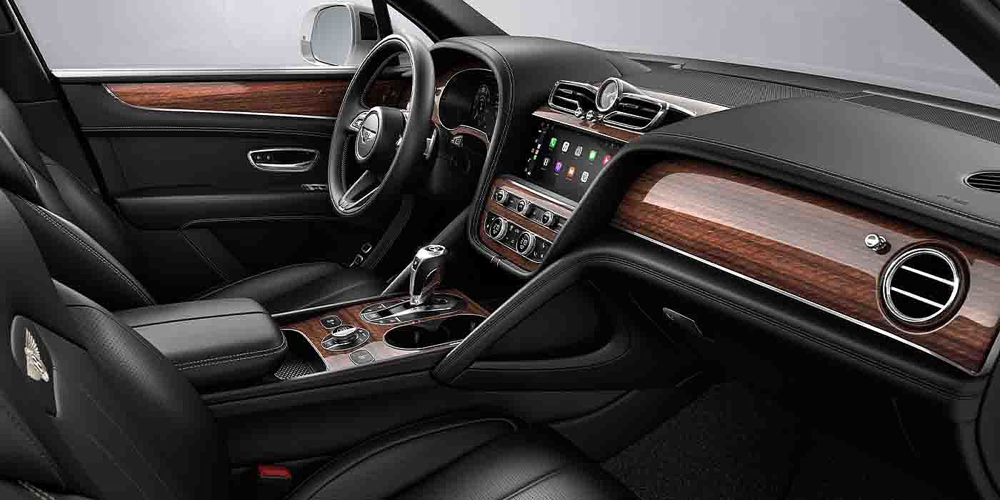 Bentley Emirates -  Dubai Bentley Bentayga EWB interior with a Crown Cut Walnut veneer, view from the passenger seat over looking the driver's seat.