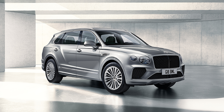 Bentley Dubai Bentley Bentayga Extended Wheelbase SUV front three quarter in Moonbeam paint with a grey background