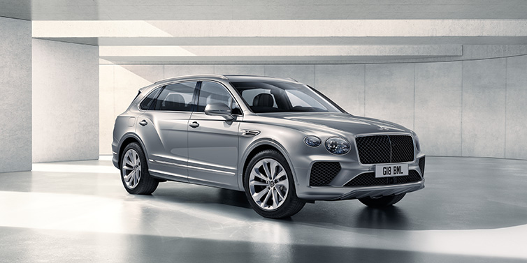 Bentley Dubai Bentley Bentayga Extended Wheelbase SUV front three quarter in Moonbeam paint with a grey background