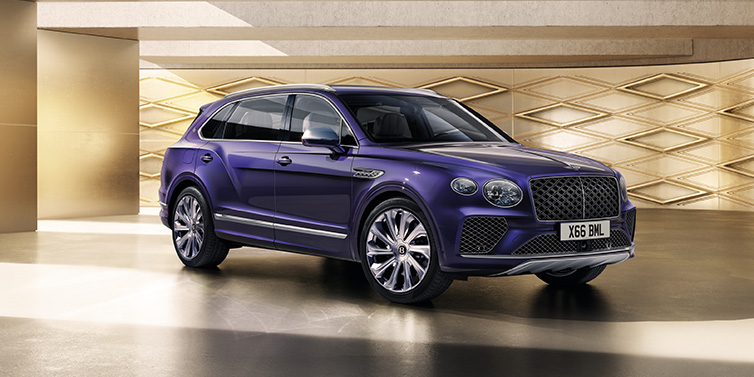 Bentley Dubai Bentley Bentayga Extended Wheelbase Mulliner SUV front three quarter in Tanzanite Purple paint with a gold patterned background