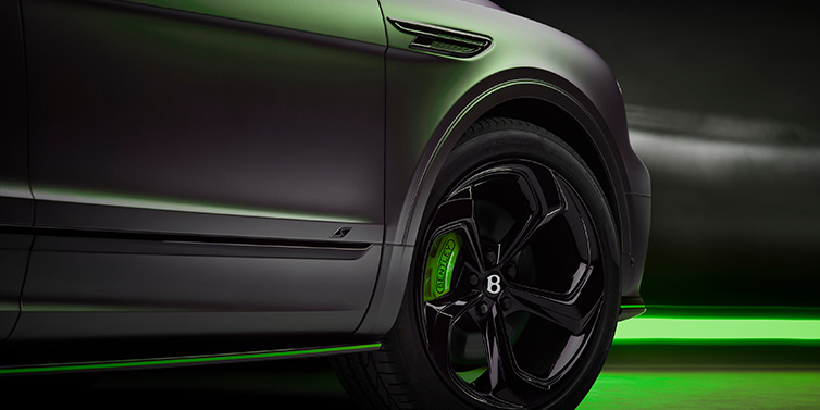 Bentley Dubai Bentley Bentayga S Black Edition SUV exterior wheel detail with Cyber Green brakes with Anthracite Satin paint