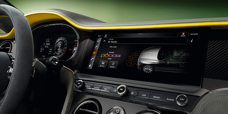 Bentley Dubai Bentley Continental GTC Speed convertible front interior centre console with MMI screen showing Air Quality visualisation surrounded by Cyber Yellow by Mulliner and Gravity Grey hides and high gloss carbon fibre veneer